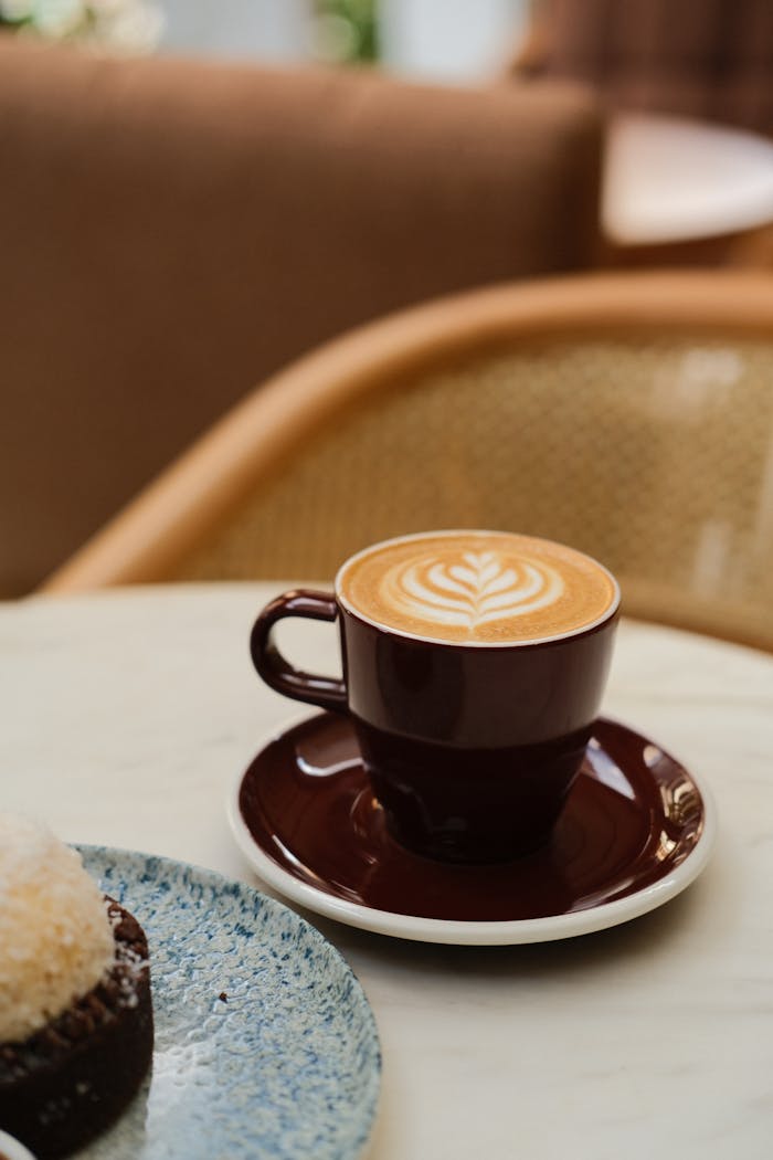 A cup of coffee and a cake on a table